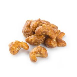 Pile of honey roasted cashews on a white background